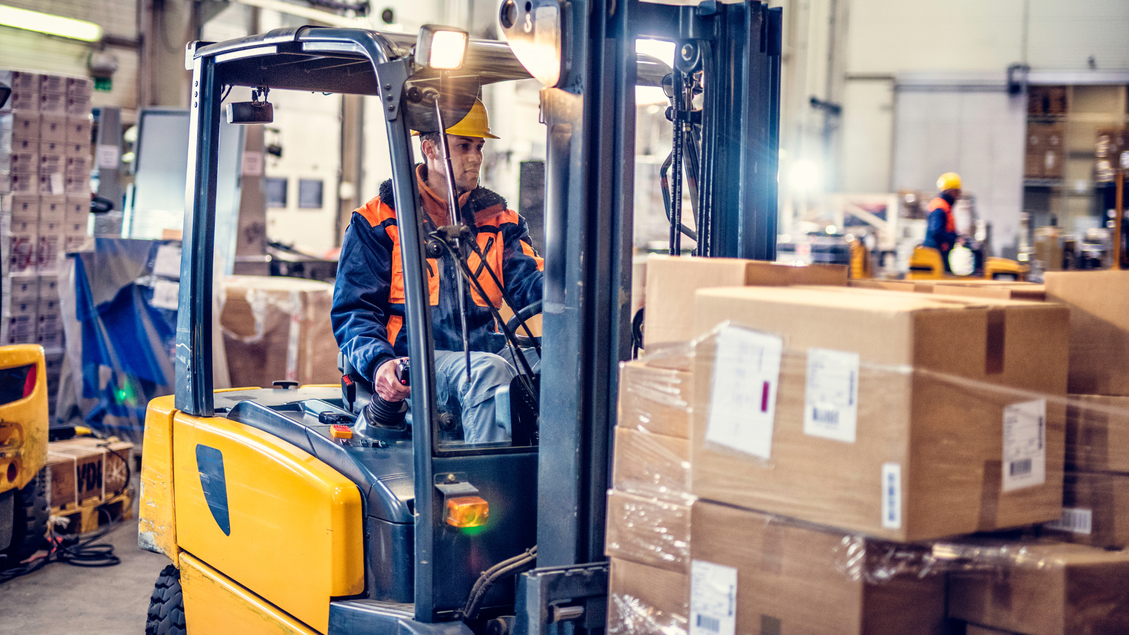 Someone using a forklift to move boxes