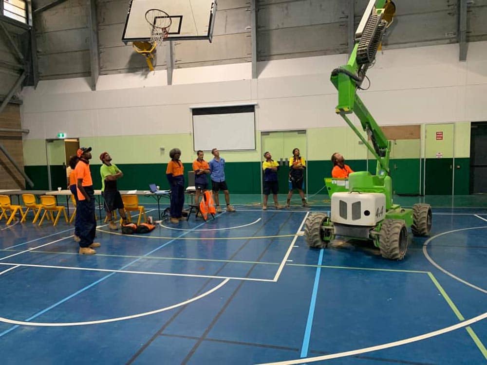 An EWP in action inside a sporting hall in Cairns