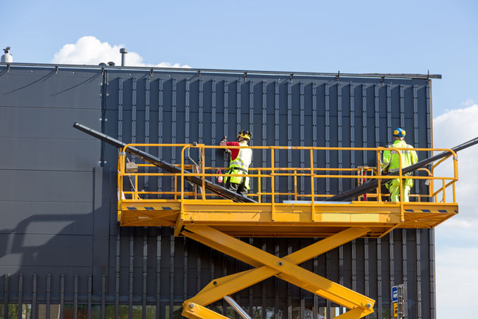 Yellow Rough Terrain Scissor Lift — Global Hire & Services in Portsmith, QLD
