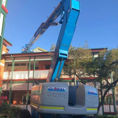 A hire crane working over a home roof in Cairns
