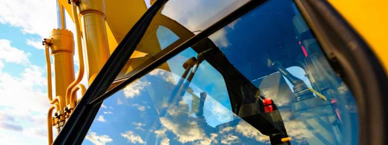 Close Up Image Of Yellow Tractor Windshield